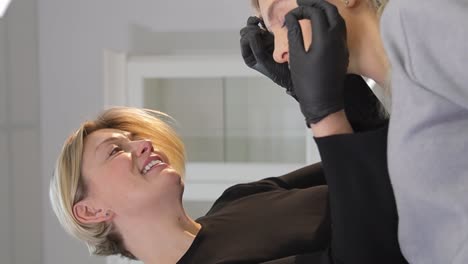 microblading permanent makeup tattoo close up eyebrow tattoo in beauty salon the master makes permanent eyebrow makeup with a needle tattoo machine master makes permanent eyebrow makeup procedure using special needle tattoo machine to woman in beauty salon brows tattooing