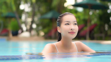 face close up asian woman in water up to her neck in swimming pool