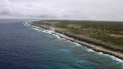 rising drone revealing rugged coastline being battered with large waves pushing water through blowholes