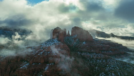 red sandstone buttes engulfed by misty clouds at sunrise in sedona, arizona. timelapse
