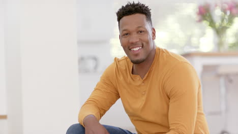 Portrait-of-happy-african-american-man-with-short-hair-at-home,-slow-motion