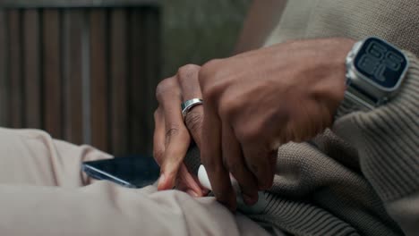 person putting earbuds into case