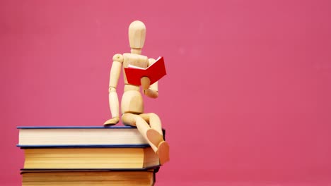 Figurine-sitting-on-stack-of-book