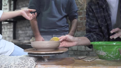 pottery class: students shaping clay