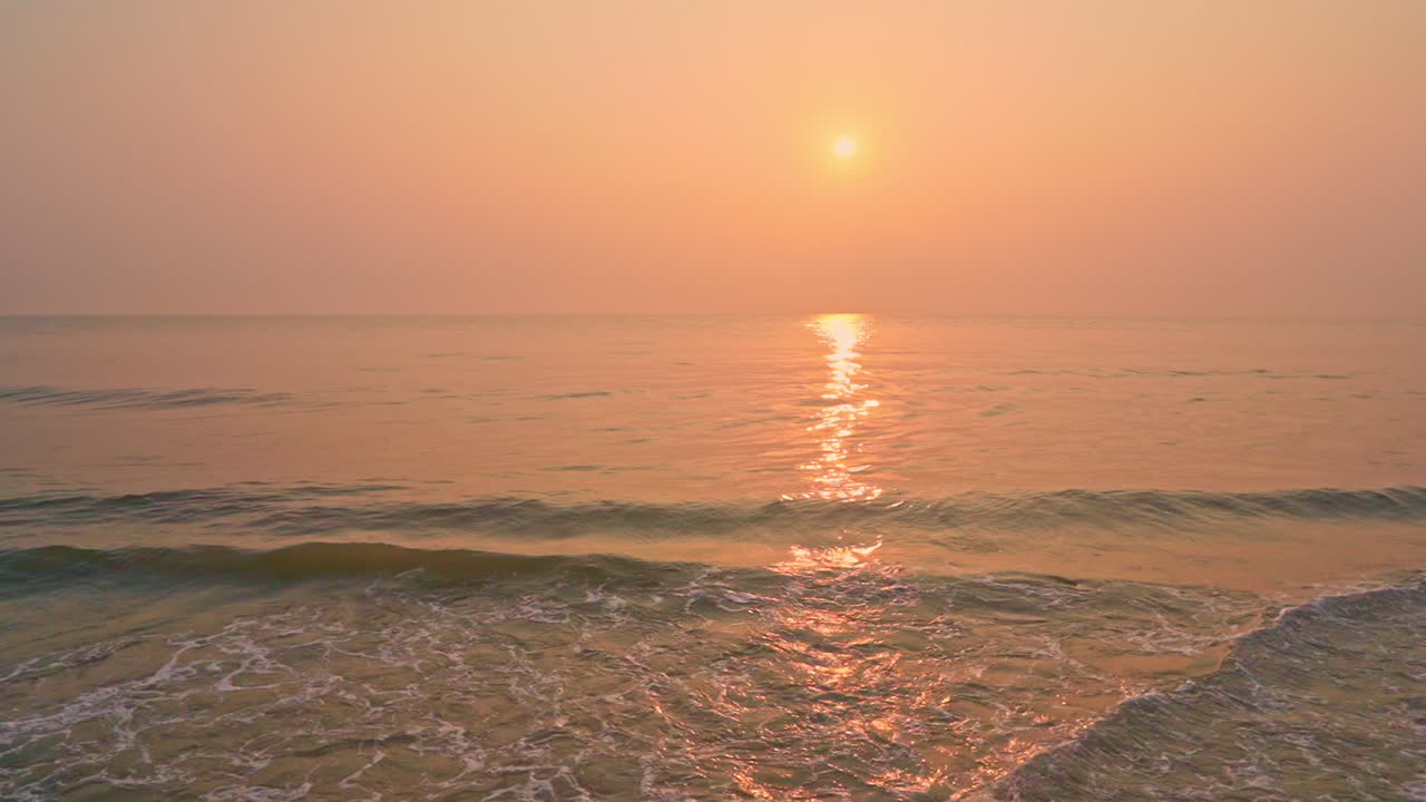 Pan across colorful ocean sunset