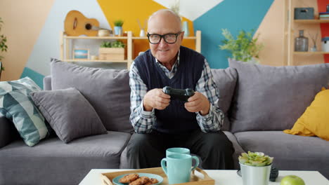 elderly man playing video games at home