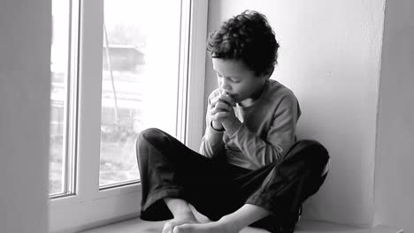 boy-praying-to-God-with-hands-held-together-with-people-sock-footage-stock-video