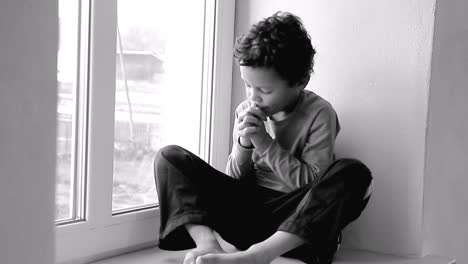 boy praying to god with hands held together with people sock footage stock video