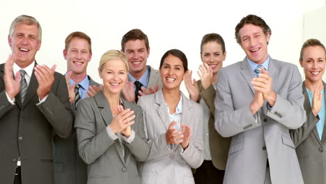 Business-people-applauding-in-front-of-camera