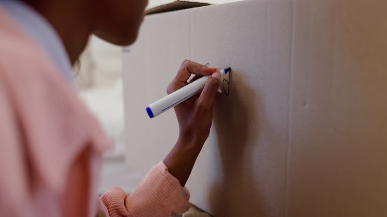 Person, hands and writing on box for new house