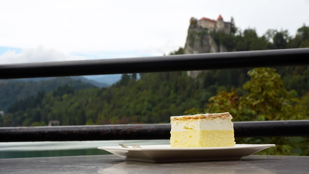 Closeup at Bled Cream Cake Kremšnita dessert, outdoor restaurant table, Slovenia