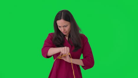 Sad-Indian-woman-measuring-her-waist-Green-screen