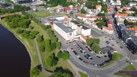 aerial view of shopping mall building, parking and riverside park in downtown neighborhood of kaunas, lithuania, drone shot