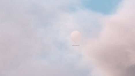 spy balloon revealed from behind clouds