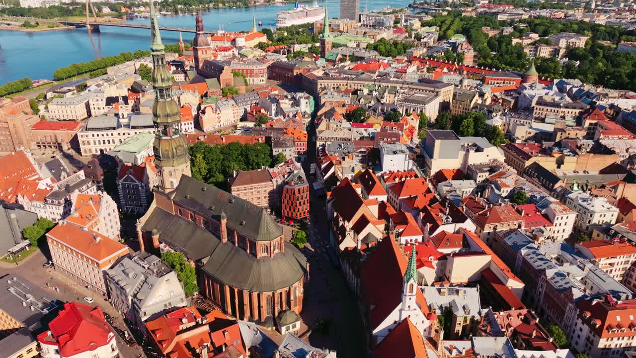 Drone establishes Riga skyline with church towers and Daugava in background