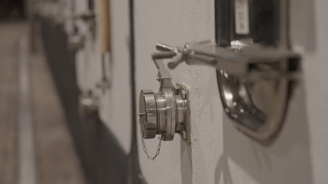 Close view of stainless valve on wine fermentation tank in cellar