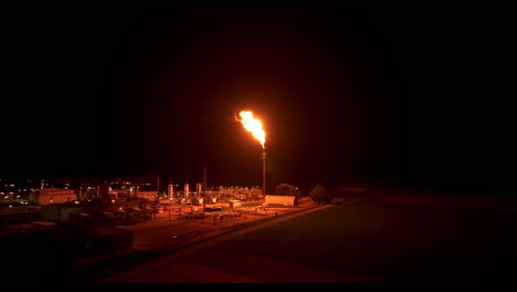 gas flaring illuminates the surrounding area with its radiant light - drone flying forward