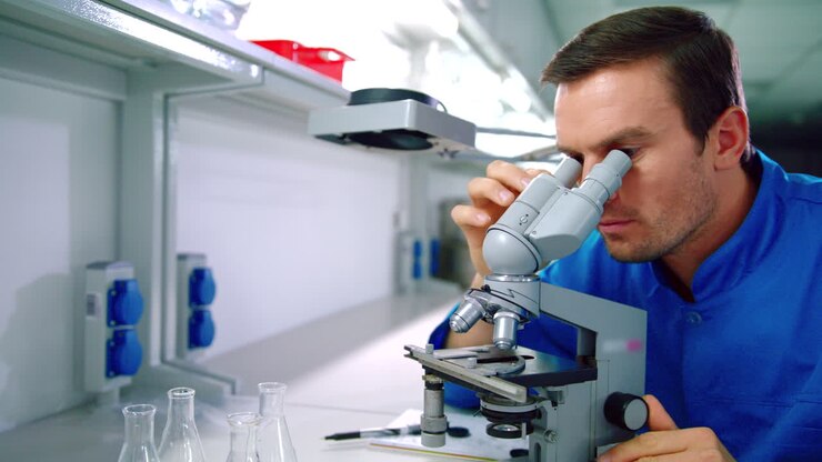 Scientist microscope. Man scientist doing microscope research in laboratory