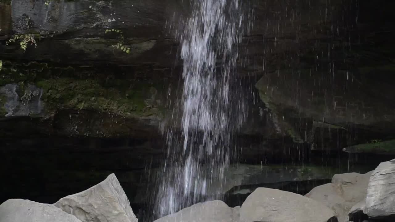 Waterfall with dark background and granite rocks