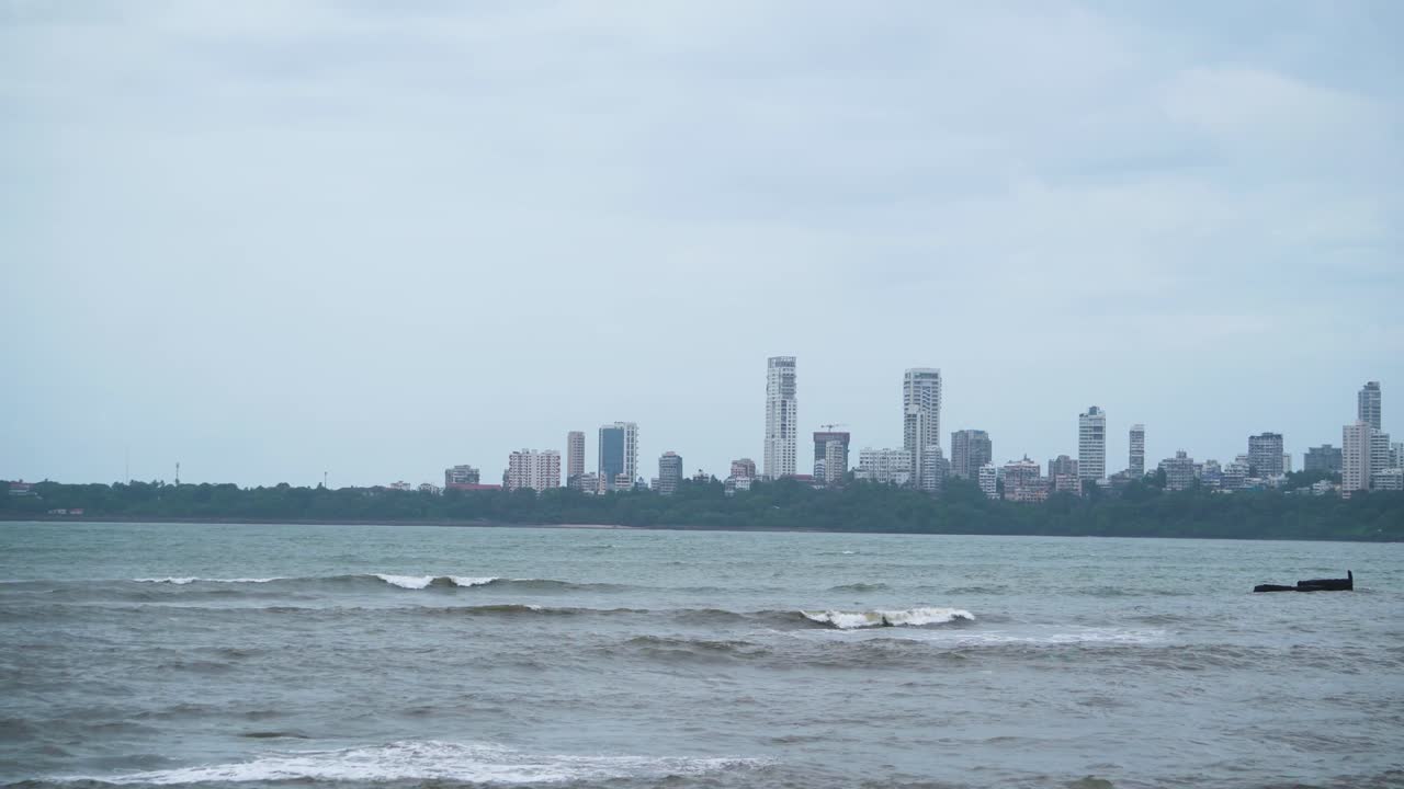Skyline buildings of Mumbai with sea waves on a cloudy monsoon day