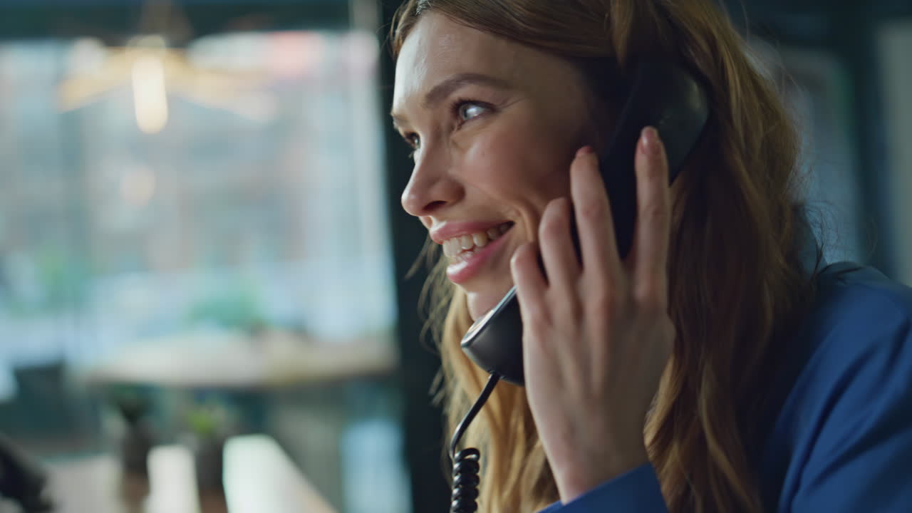 Smiling consultant talking telephone in office workspace closeup. Woman call