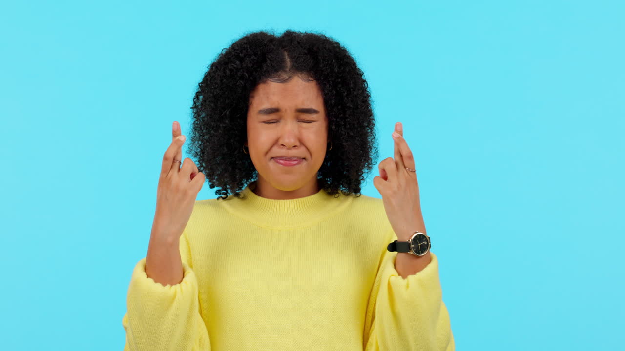 Young african woman, fingers crossed