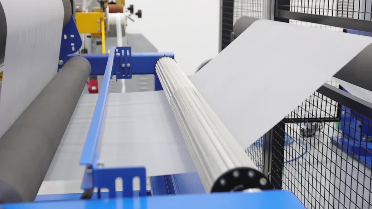 EVA plastic film going through shaft roller in machine