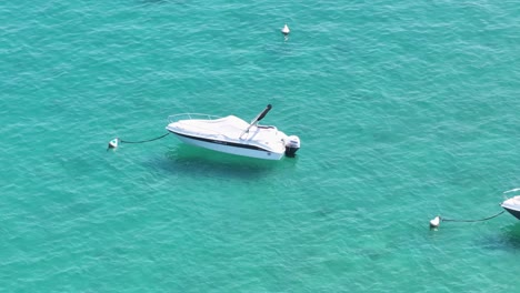 anchored motorboats at blueish turquoise waters of lido galeazzi italy