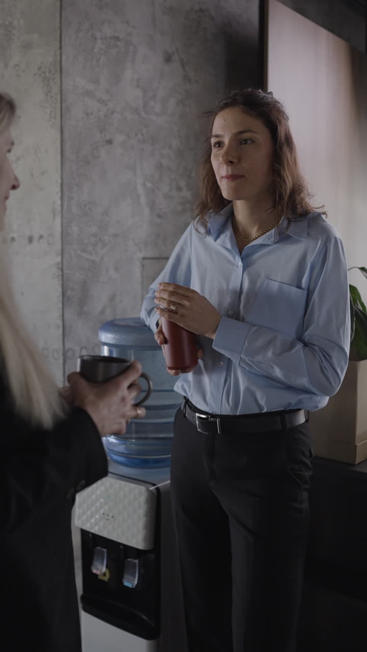 Two Women Talking at Water Cooler