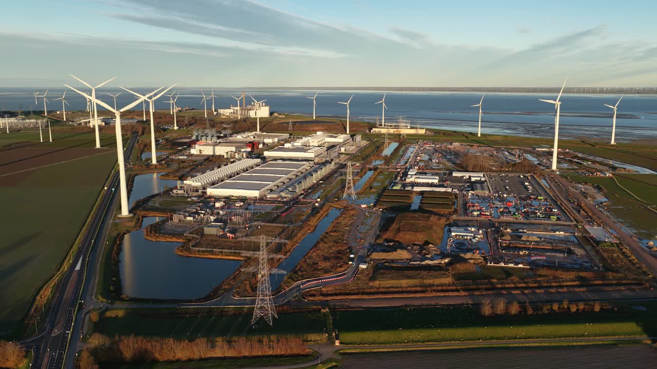 Aerial drone view of a major data center expansion (new build) next to an existing hyperscaler facility in Eemshaven, Netherlands. Highlights global cloud infrastructure growth