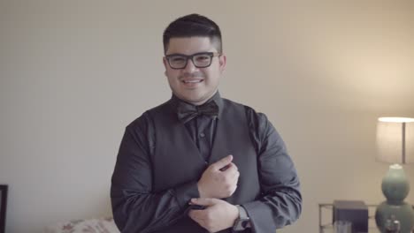 Groom-fixing-cufflinks-on-wedding-day