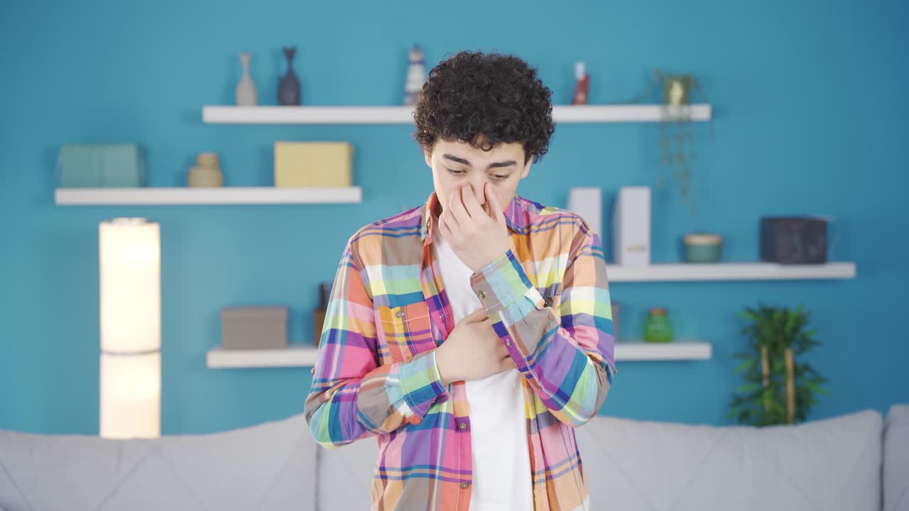 Boy suffering from heart palpitations or pain at home.