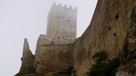 ancient stone castle tower in fog