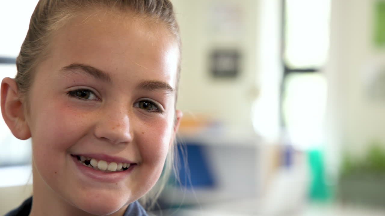 Smiling girl in classroom, enjoying school day with bright enthusiasm, copy space