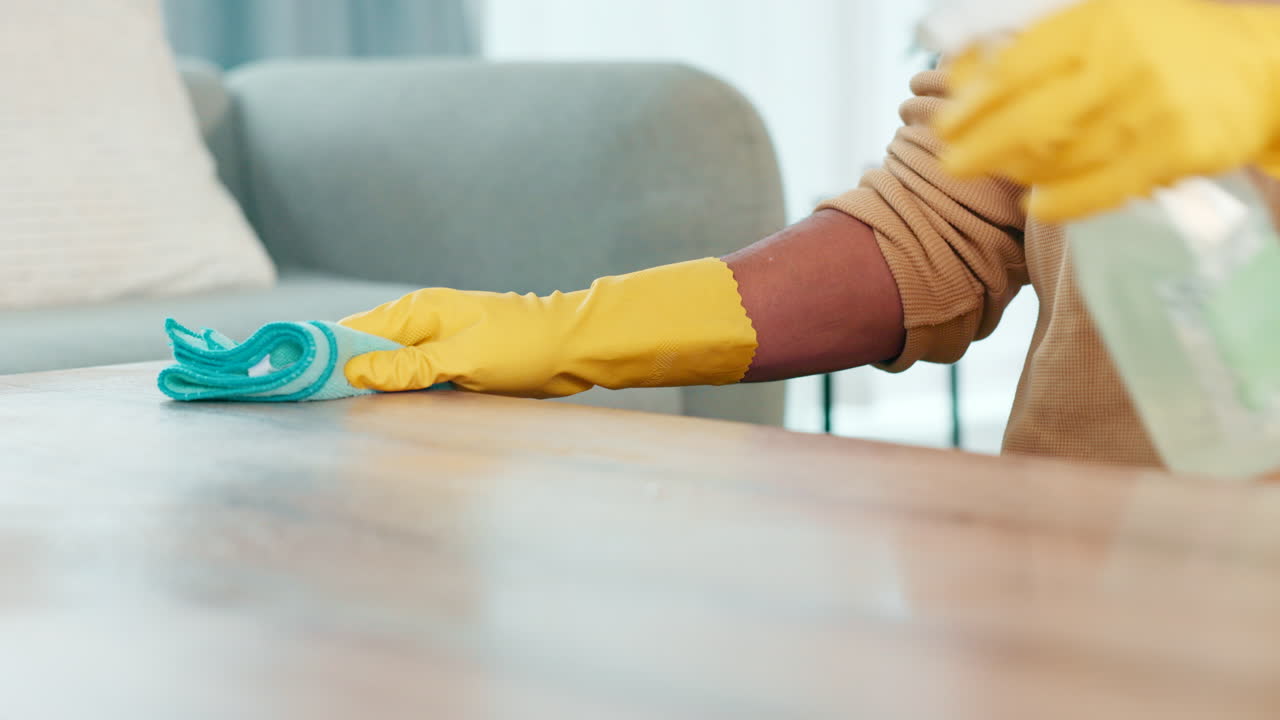 Man cleaning a table at home