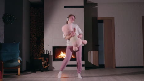 woman dancing in cozy living room by fireplace