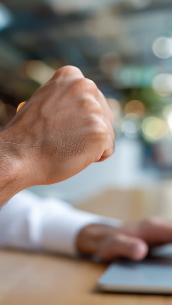 Hand clenches in triumph. Fingers tense, showing effort. Focus on success, achievement. Ideal for workplace, motivation scenes. Emotion: determination, joy, victory. Close-up captures strong gesture