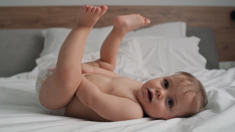 Video-of-cute-little-girl-after-the-bath-lying-on-the-bed.