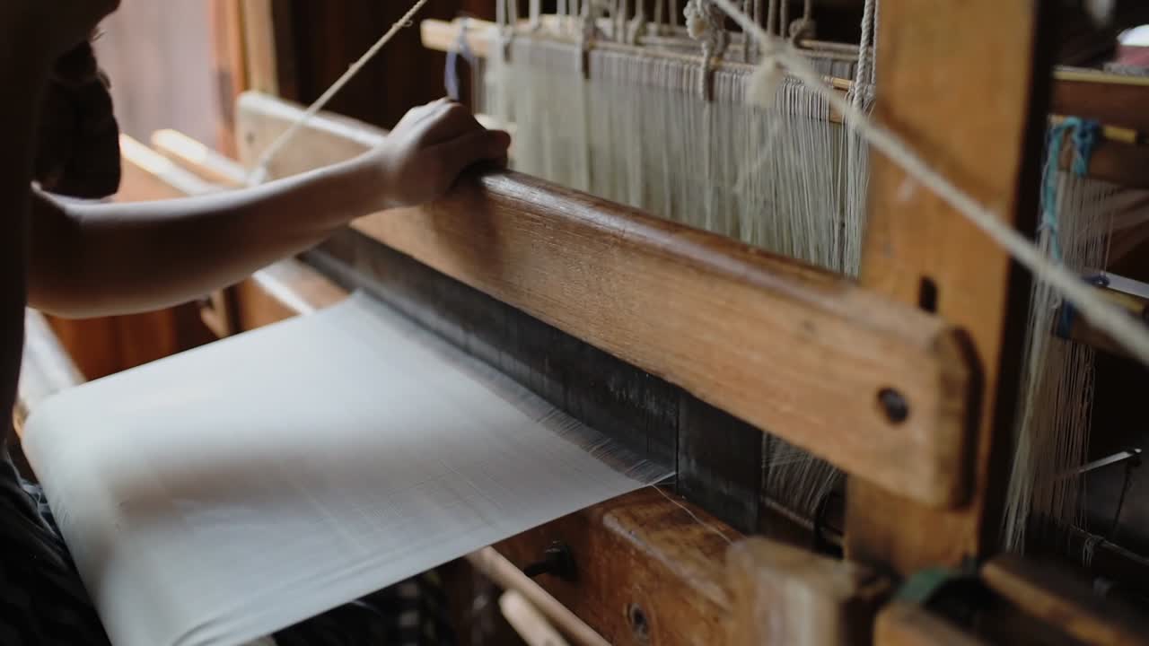 Woman weaving threads with the traditional technique in Myanmar, Inle Lake