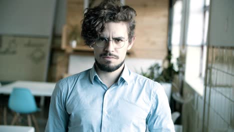 front view of young man in eyeglasses posing