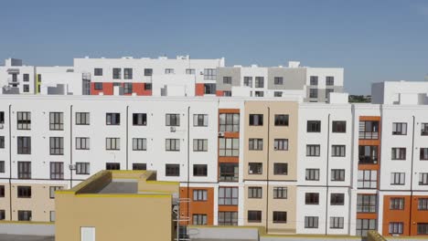 tilt up drone view over modern residential buildings with colorful facades located in new district of contemporary city