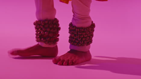 Close-Up-On-Feet-And-Bells-Of-Female-Kathak-Dancer-Performing-Dance-Wearing-Traditional-Indian-Dress-Against-Purple-Background-9