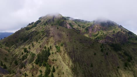 clouds over mount batur volcano crater in bali, indonesia