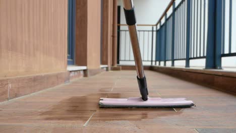mop cleaning a wet tiled floor