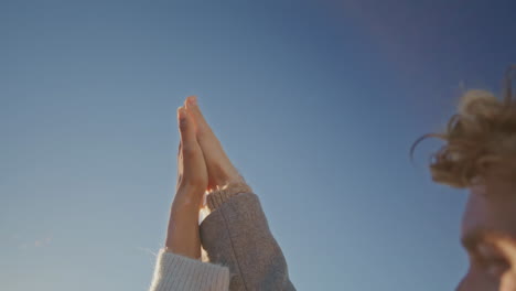 Loving pair hands touching blue sky background closeup. Lovers palms connecting
