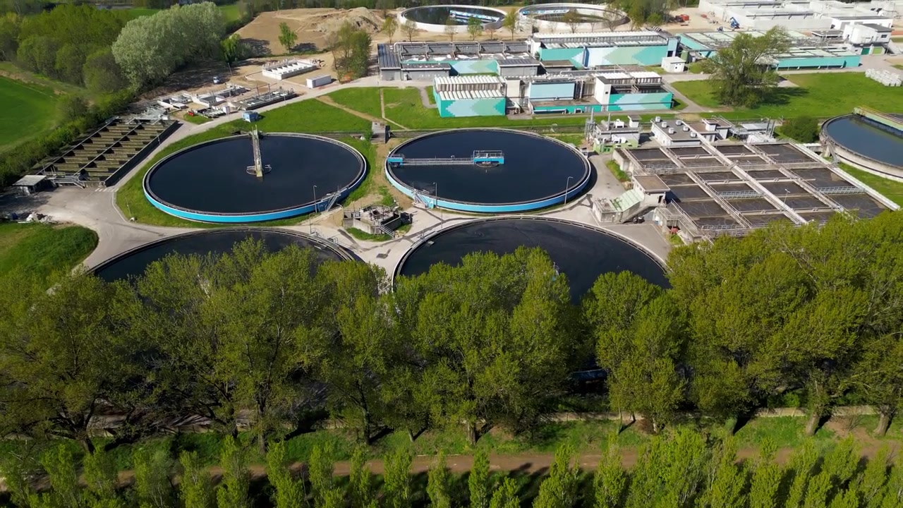 Aerial drone view of a water treatment facility in Peschiera Borromeo near Milan Italy. Industrial infrastructure processing and purification of urban water resources.