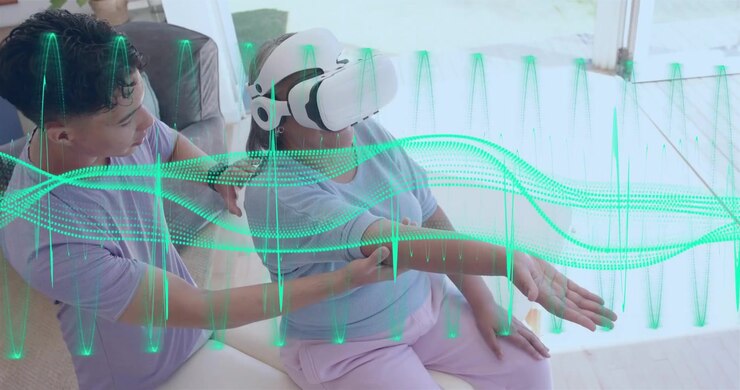 Video verticale: Assistente che tocca un visore VR guidando una donna che allunga il braccio per la riabilitazione con un'onda color verde acqua in sovrimpressione.