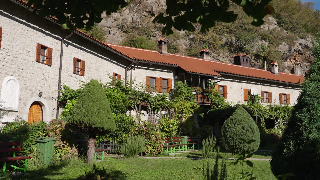 Stone house and beautiful green garden in sunny Montenegro, slow pan
