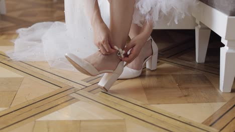 bride getting ready in white dress and high heels