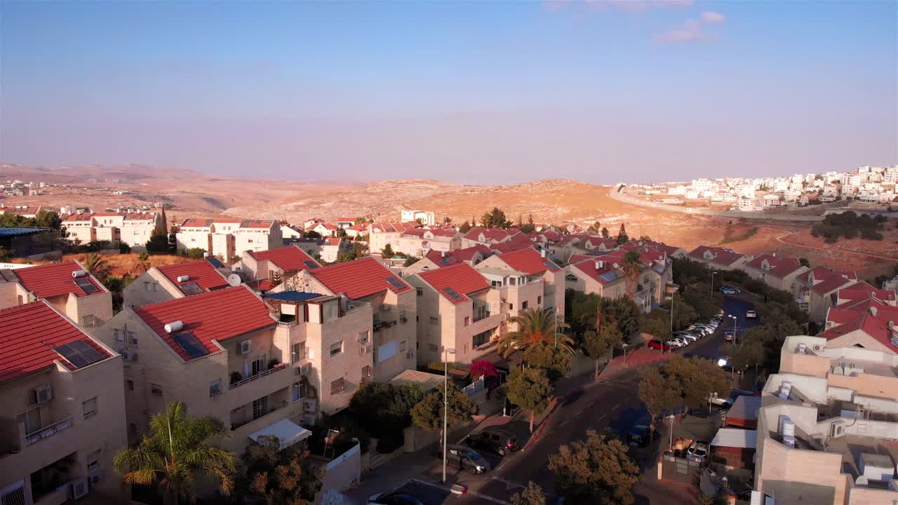 Aerial View of a Residential Area with Red Roofs in an Arid Landscape